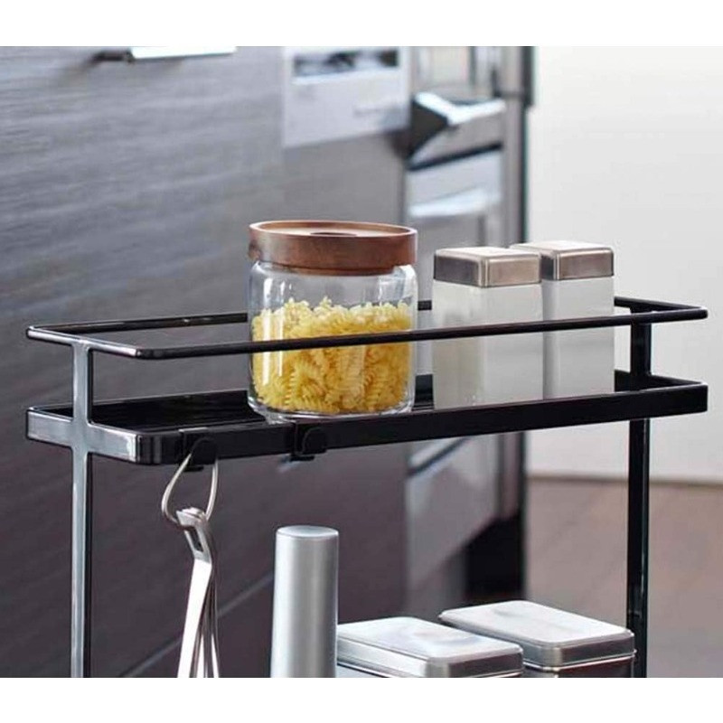 Close-up of top shelf with jar of pasta and salt/pepper shakers on a black frame cart